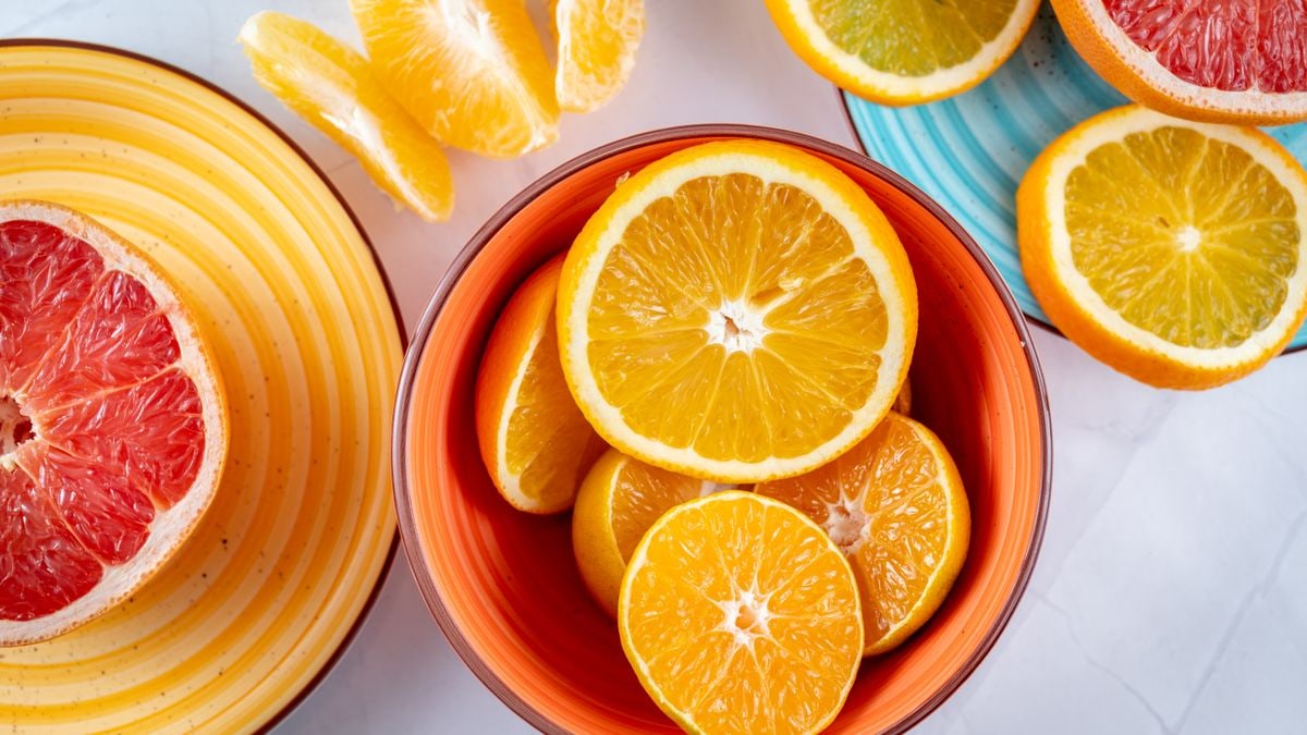 Citrus slices creatively arranged in ceramic bowls, showcasing a vivid and fresh presentation of grapefruits and oranges.